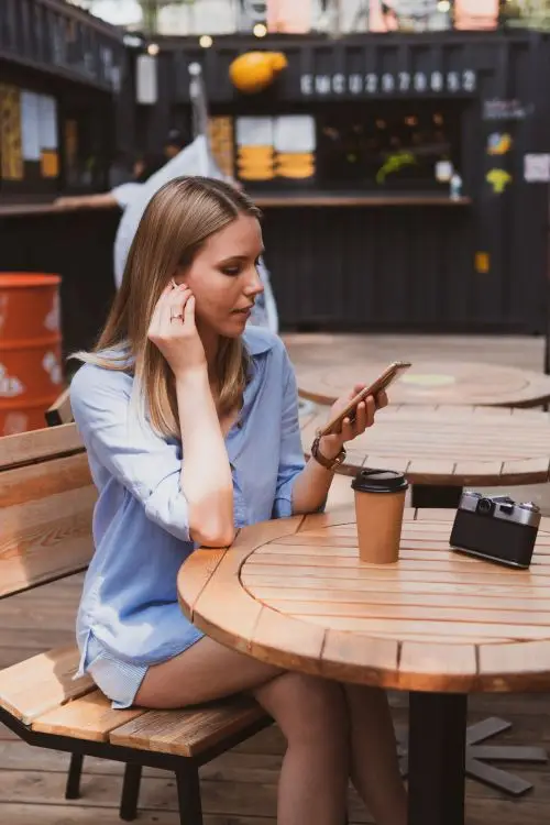 Young charming woman enjoying coffee while listening.